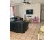 Inviting living room featuring tile flooring, a ceiling fan, and neutral walls at 1485 Gainsville Dr, Deltona, FL 32725