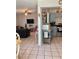 Open-concept space showcasing the living room adjacent to the kitchen with neutral tile floors at 1485 Gainsville Dr, Deltona, FL 32725