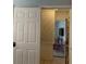 Open doorway to a living room with neutral walls and a television at 1485 Gainsville Dr, Deltona, FL 32725