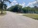 Wide shot of the street, showcasing the house's location in a quiet neighborhood at 1485 Gainsville Dr, Deltona, FL 32725
