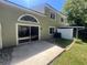 View of the backyard featuring a patio, sliding glass door, and a fenced perimeter at 15 Misners Trl, Ormond Beach, FL 32174