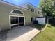 View of the backyard featuring a patio, sliding glass door, and a fenced perimeter at 15 Misners Trl, Ormond Beach, FL 32174