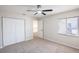 An inviting bedroom with neutral carpet, ceiling fan, and a window at 15 Misners Trl, Ormond Beach, FL 32174
