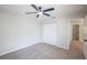 A cozy bedroom features carpet, ceiling fan, and a closet for storage at 15 Misners Trl, Ormond Beach, FL 32174