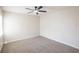 A bright bedroom featuring a ceiling fan and neutral carpet at 15 Misners Trl, Ormond Beach, FL 32174