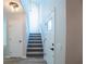 Front entryway features carpeted stairs, a front door with glass, and a closet at 15 Misners Trl, Ormond Beach, FL 32174