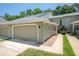 Charming condo with an attached garage and a walkway leading to the front entrance at 15 Misners Trl, Ormond Beach, FL 32174