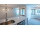 Open-concept kitchen with stainless steel sink, quartz countertops, and adjacent dining area at 15 Misners Trl, Ormond Beach, FL 32174