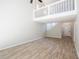 Open-concept living room with wood floors, loft area, and staircase at 15 Misners Trl, Ormond Beach, FL 32174