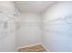 Walk-in closet features white wire shelving and wood floors at 15 Misners Trl, Ormond Beach, FL 32174