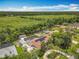 Gorgeous aerial view of a beautiful home with a pool overlooking lush greenery and a tranquil waterway at 1520 Stone Trl, Enterprise, FL 32725