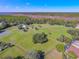 Expansive property featuring lush green fields and mature trees under a bright blue sky at 1520 Stone Trl, Enterprise, FL 32725