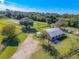 Aerial view of house and property featuring a long driveway, large barn-like structure and lots of trees at 1520 Stone Trl, Enterprise, FL 32725