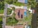 Birds eye view of home with solar panels, boat dock and a screened in pool and large driveway at 1520 Stone Trl, Enterprise, FL 32725