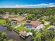 Lovely aerial view of a waterfront home with a screened pool, solar panels, fenced yard, and boat dock at 1520 Stone Trl, Enterprise, FL 32725