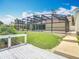 Backyard featuring the pool lanai, green lawn, trees and access to a waterway at 1520 Stone Trl, Enterprise, FL 32725