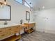 Luxurious primary bath featuring double vanities, custom cabinetry, and a frameless glass shower at 1520 Stone Trl, Enterprise, FL 32725