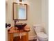 Unique powder room featuring a live-edge wood countertop with a vessel sink and a modern toilet at 1520 Stone Trl, Enterprise, FL 32725