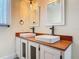 Bathroom featuring a double sink vanity with wood countertop and rustic finishes at 1520 Stone Trl, Enterprise, FL 32725