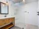 Modern bathroom with a white vanity, a mirror, and a frameless glass-enclosed walk-in shower at 1520 Stone Trl, Enterprise, FL 32725