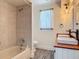 Well-lit bathroom featuring a combination shower and tub, double sink vanity, and vintage-inspired lighting at 1520 Stone Trl, Enterprise, FL 32725