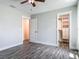 Spacious bedroom showing a ceiling fan, wood-look flooring, and a door to the closet at 1520 Stone Trl, Enterprise, FL 32725