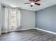 Bedroom with a window, neutral walls, and modern wood-look flooring at 1520 Stone Trl, Enterprise, FL 32725