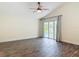 Tranquil bedroom with tile floors and sliding glass doors that lead to a screened lanai with pool at 1520 Stone Trl, Enterprise, FL 32725