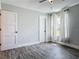 Bedroom with a ceiling fan, window, wood-look flooring, and natural lighting at 1520 Stone Trl, Enterprise, FL 32725