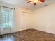 Bedroom with a window, ceiling fan, and closet with sliding doors at 1520 Stone Trl, Enterprise, FL 32725