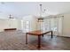 The dining area showcases modern lighting and large windows with sheer curtains for natural light at 1520 Stone Trl, Enterprise, FL 32725