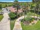 Charming single-story home featuring well-manicured lawns, mature palm trees, and a long private drive at 1520 Stone Trl, Enterprise, FL 32725