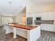 Well-appointed kitchen with wood countertops, stainless steel appliances, and ample cabinet space at 1520 Stone Trl, Enterprise, FL 32725
