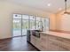 Bright open concept kitchen features a large island with seating and views of the pool area at 1520 Stone Trl, Enterprise, FL 32725