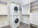 Well-lit laundry room featuring a stacked washer and dryer unit and custom closet with shelving at 1520 Stone Trl, Enterprise, FL 32725