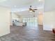 Spacious open layout of the living room featuring a modern kitchen and sliding glass doors to a pool area at 1520 Stone Trl, Enterprise, FL 32725