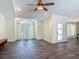 Bright living room with a front door, a large window, and wood-look tile flooring at 1520 Stone Trl, Enterprise, FL 32725