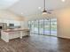 Bright living room with a kitchen island, vaulted ceilings, and a view of the pool area at 1520 Stone Trl, Enterprise, FL 32725