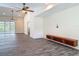 Open-concept living room with high ceilings, fan, and pool view through the sliding glass door at 1520 Stone Trl, Enterprise, FL 32725