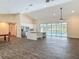 Open-concept living space featuring tile flooring, a kitchen island, and sliding glass doors to the pool at 1520 Stone Trl, Enterprise, FL 32725