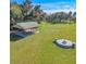 Outdoor pavilion with a concrete foundation and a nearby stone fire pit in a grassy area at 1520 Stone Trl, Enterprise, FL 32725
