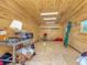Spacious interior of shed with wood paneling, lighting, and storage at 1520 Stone Trl, Enterprise, FL 32725