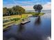 Scenic waterfront featuring a dock, pier, picnic area, and mature trees at 1520 Stone Trl, Enterprise, FL 32725