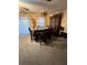 Cozy dining room with hardwood table and chairs, chandelier, and carpeted flooring at 15555 Sw 46Th Cir, Ocala, FL 34473
