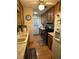 Functional kitchen with wood cabinetry, laminate countertops, and neutral flooring at 15555 Sw 46Th Cir, Ocala, FL 34473