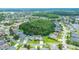 An aerial view of the property highlighting the surrounding community and nearby wooded area with a lake at 1910 Creekwater Blvd, Port Orange, FL 32128