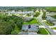 Overhead view of a home with a screened-in pool, lush trees, and landscaping near a lake at 1910 Creekwater Blvd, Port Orange, FL 32128