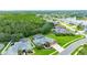Overhead view of a home with a screened-in pool area surrounded by trees and a well-maintained lawn at 1910 Creekwater Blvd, Port Orange, FL 32128