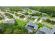 Beautiful aerial view of home, green lawn, solar panels, screened pool, and landscaping in a lovely neighborhood at 1910 Creekwater Blvd, Port Orange, FL 32128