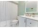 Bathroom featuring green walls, white shower curtain, marble flooring, and modern white vanity at 1910 Creekwater Blvd, Port Orange, FL 32128